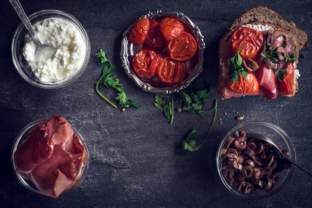 Sandwiches and ingredients on the dark background with blank spaceの写真素材