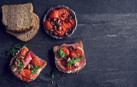 Sandwiches and ingredients on the dark background with blank spaceの写真素材