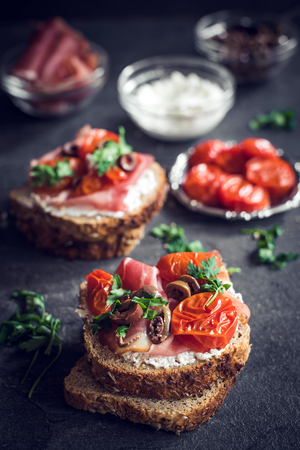 Sandwiches with grilled tomatoes,cheese and prosciuttoの写真素材