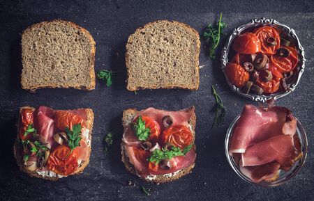 Sandwiches with prosciutto,cream cheese and grilled tomtoesの写真素材