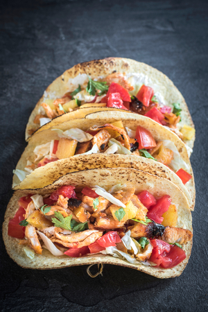 Tortilla sandwiches with chicken meat in bbq sauce and vegetables の写真素材