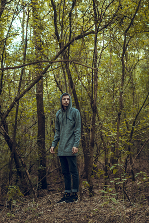 Man posing deep in the woods,selective focusの写真素材