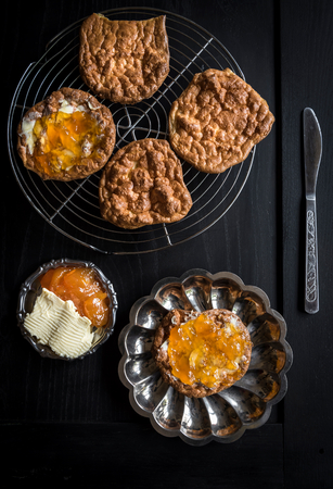 Sweet cookies with jam and butter served on dark background の写真素材