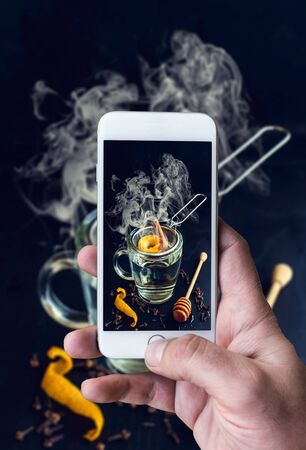 Man photographing fresh prepared teaの写真素材