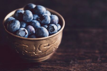 Fresh picked blueberries in the metal cup,selective focusの写真素材