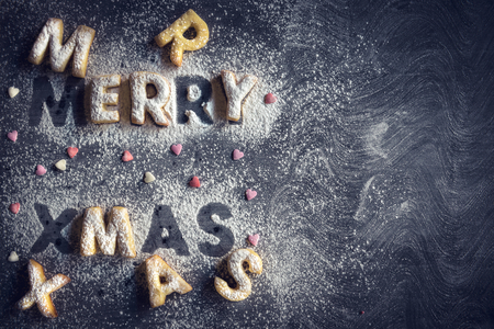 Merry Christmas cookies on dark background with blank space の写真素材
