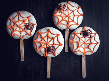 Spider cookie lollipops on dark background 
の写真素材