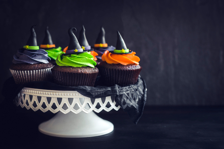 Witch hat cupcakes  served on dark background with blank space の写真素材