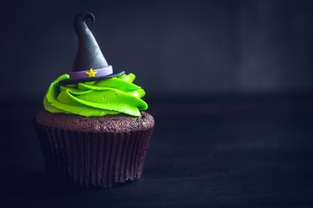 Witch hat cupcake on dark background with blank space の写真素材