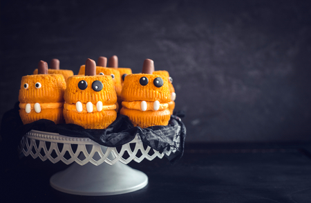 Halloween homemade cupcakes served on dark background with blank spaceの写真素材