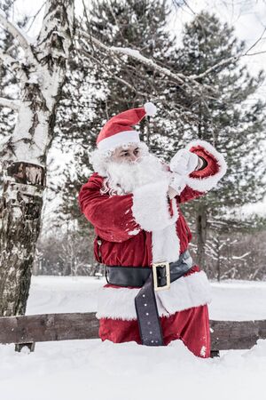 Santa Claus outdoor looking on his watchの写真素材