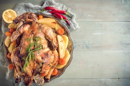 Whole roasted turkey on wooden background with blank spaceの写真素材