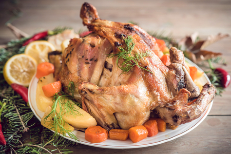Close up whole roasted turkey served on the plate with potatoes,selective focusの写真素材