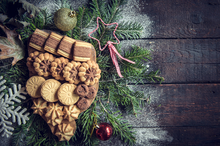 Served Christmas cookies on wooden background with blank spaceの写真素材