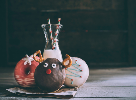 Christmas donuts with milk served on wooden background with blank spaceの写真素材