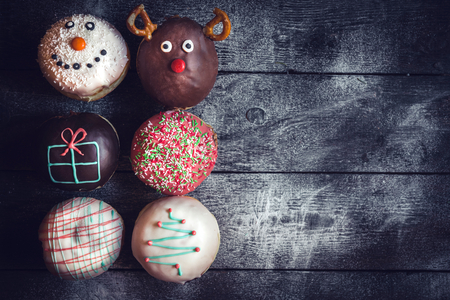 Homemade Christmas donuts on wooden background with blank spaceの写真素材