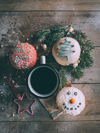 Homemade Christmas donuts served on wooden backgroundの写真素材