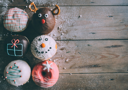 Christmas donuts served on wooden background with blank spaceの写真素材