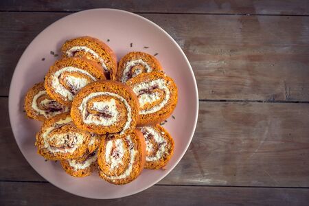 Ajvar rolls with cheese and ham on wooden background with blank spaceの写真素材