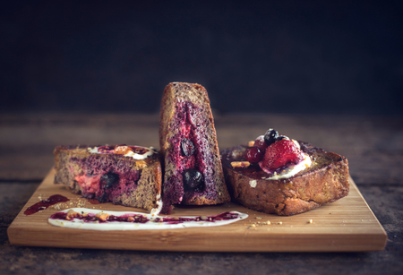 Sweet toast sandwiches with berries served on wooden boardの写真素材