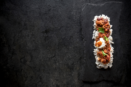 Minced lamb in sauce with white rice served on dark background with blank spaceの写真素材