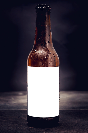 Bottle of beer with blank label on the dark background の写真素材