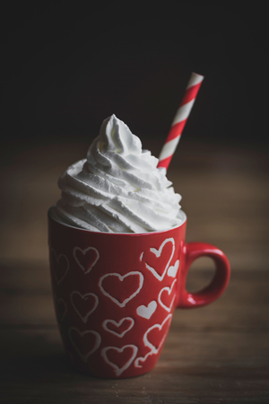 Cup of coffee with cream on the top,selective focus and valentines day concept の写真素材