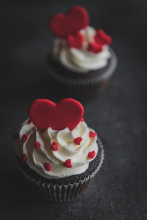 Heart shapes cup cakes on the dark background,selective focus and valentines day conceptの写真素材
