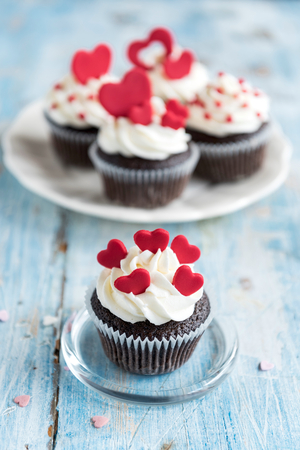 Sweet homemade cupcakes with hearts on the top,valentines day concept and selrctive focusの写真素材
