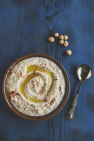 Homemade humus served in the plate on wooden background,selective focus の写真素材
