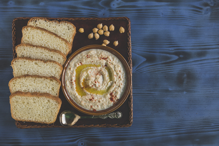 Homemade humus and sliced bread served on the plate,blank space and selective focus の写真素材