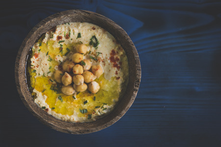 Homemade humus served on the wooden background with blank space の写真素材