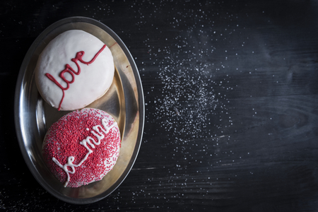 Donuts with love and be mine sign served,blank space and selective focus の写真素材