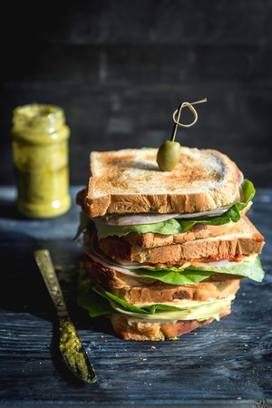 Big toast sandwich with pesto and ham,selective focus の写真素材