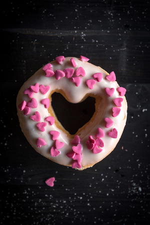 Heart shape donut on the dark background,selective focus の写真素材
