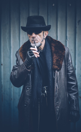 Portrait of man with smoking pipe,selective focus の写真素材