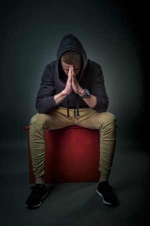 Portrait of worried man with the hoodie on his head の写真素材