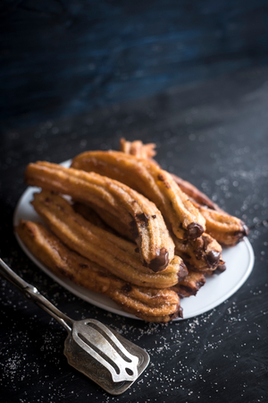 Mexican churros stuffed with chocolate cream,selective focus の写真素材