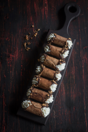 Sweet homemade cannoli with almonds and chocolate,selective focus の写真素材