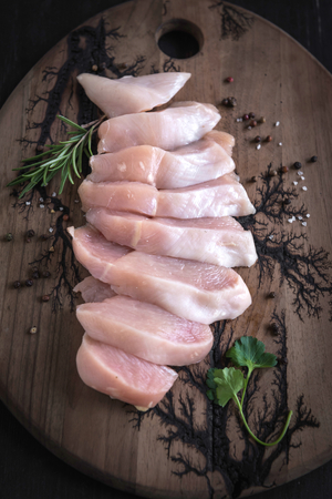 Served sliced raw chicken file with spices,selective focus の写真素材