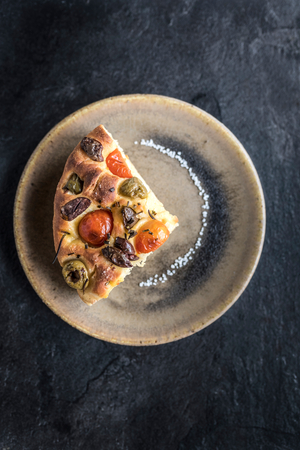 Slice of homemade Italian Focaccia served on the plate の写真素材