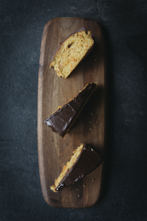 Slices of sweet carrot cake glazed with chocolate,selective focus の写真素材