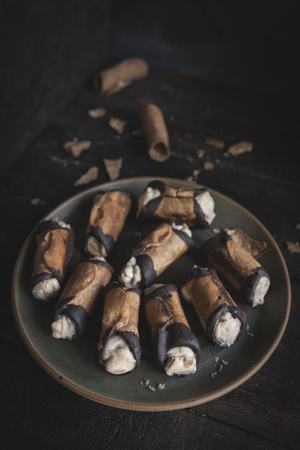 Served traditional Italian dessert cannoli with pistachios cream の写真素材