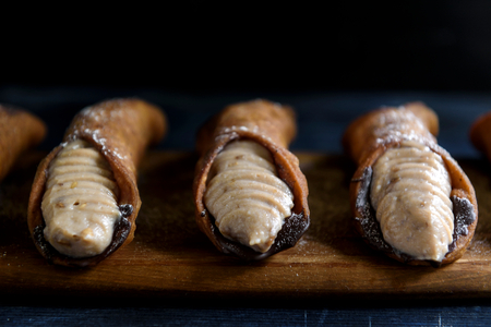 Traditional Italian dessert cannoli with ricotta and chocolate,selective focus の写真素材