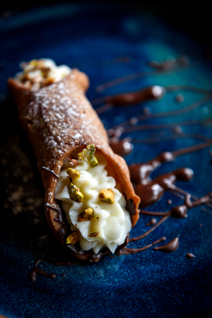 Close up to homemade cannoli with sliced pistachios and ricotta,selective focus の写真素材
