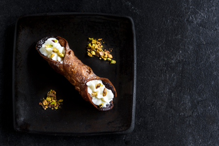 Traditional Italian dessert cannoli served on the olate,selective focus and blank spaceの写真素材