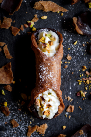 Cannoli with sliced pistachios and ricotta cheese,selective focus の写真素材