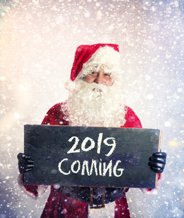 Santa Claus with chalkbord with 2019 comin sign in his handsの写真素材