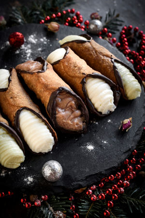 Traditional Sicilian cannoli served on the table,selective focus and Christmas decorationの写真素材