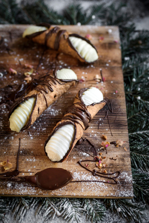 Christmas concept with traditional Sicilian cannoli served on the wooden board,selective focusの写真素材